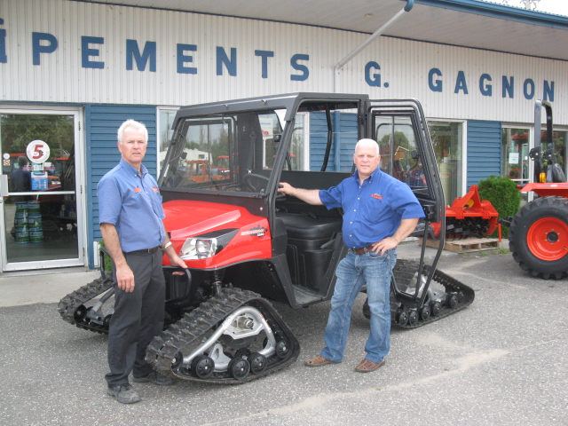 From Left to Right: Yvon and Jean Gagnon stand in front of one of their popular KIOTI utility vehicles.