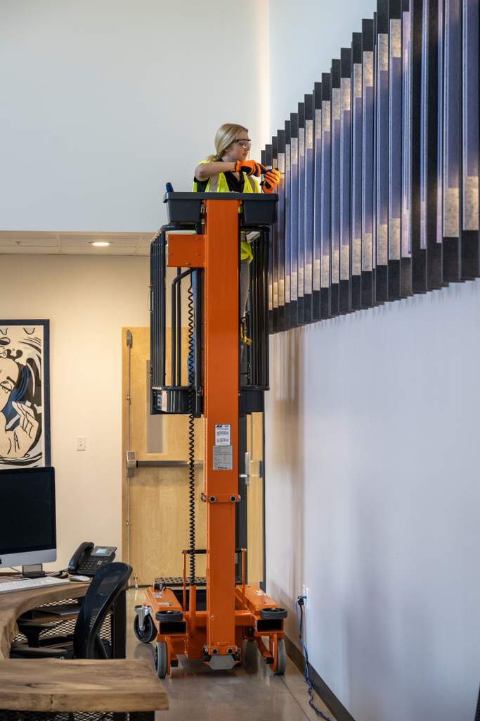 JLG 1230P low level access lift reaching up with worker