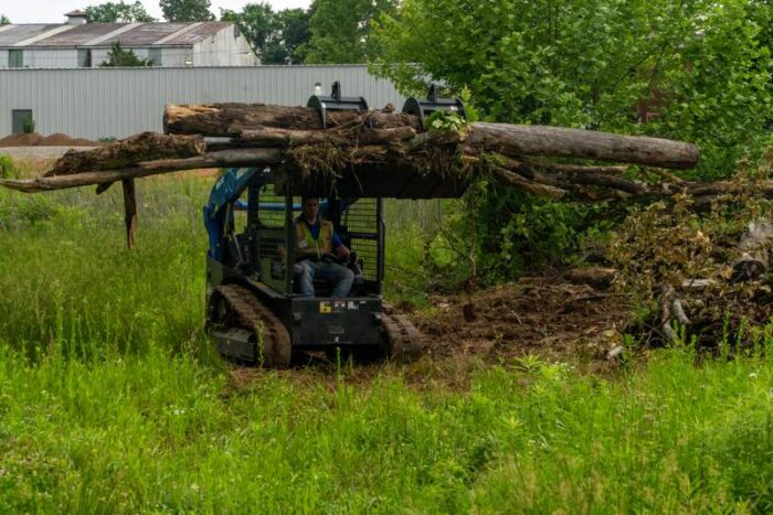 Blue Diamond Unveils HDX Series Grapple Rakes and Buckets compact track loader with logs