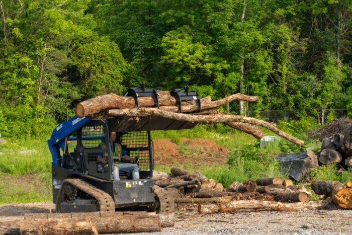 Blue Diamond Unveils HDX Series Grapple Rakes and Buckets compact track loader with logs