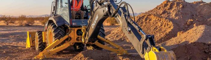 John Deere 20 P-Tier Backhoe working in the dirt