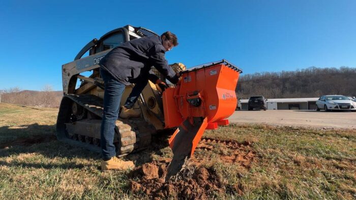 EZG Mobile Mixer on a compact track loader with a worker