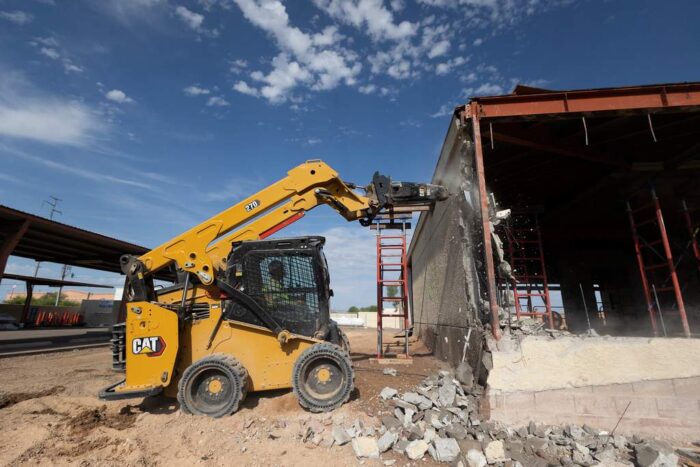 Caterpillar 270 skid steer with a breaker attachment
