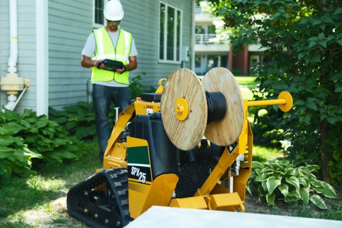 Vermeer SPX25 using a vibratory plow attachment