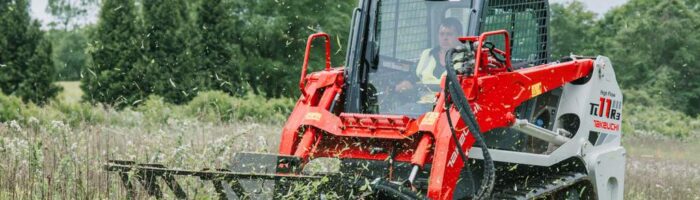 Takeuchi TL11R3 compact track loader cutting grass