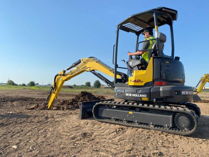 New Holland E42D mini excavator digging with ROPS