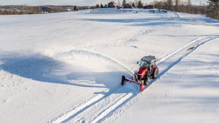 Massey Ferguson MF25 tractor in the snow with a snow thrower