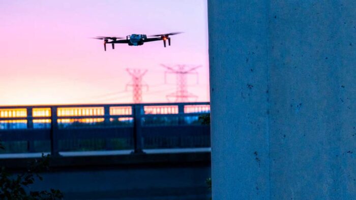 Skydio X10 drone flying next to a wall 