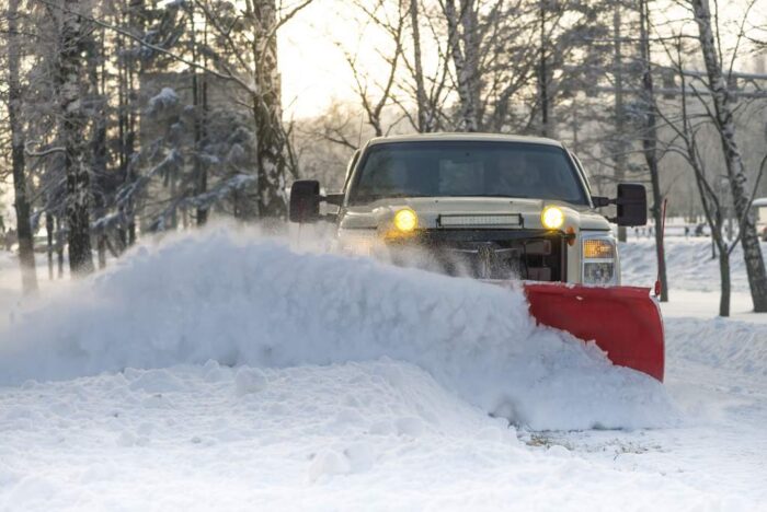 Snow plow doing snow removal after a blizzard