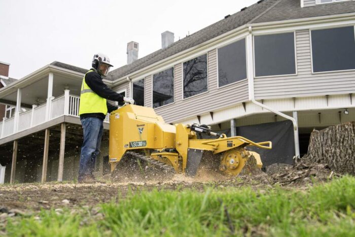 Vermeer SC30TX Electric stump cutter working in front of some apartments