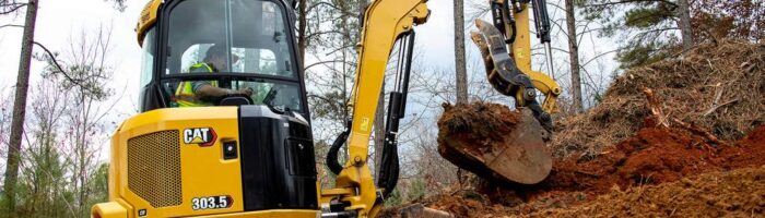 Caterpillar 303.5 mini excavator digging in the dirt 2