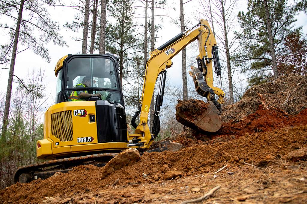 Caterpillar 303.5 mini excavator digging in the dirt 2