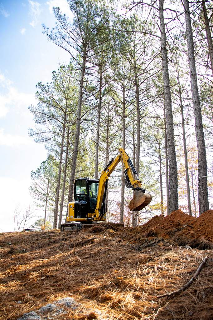 Caterpillar 303.5 mini excavator going through a forest