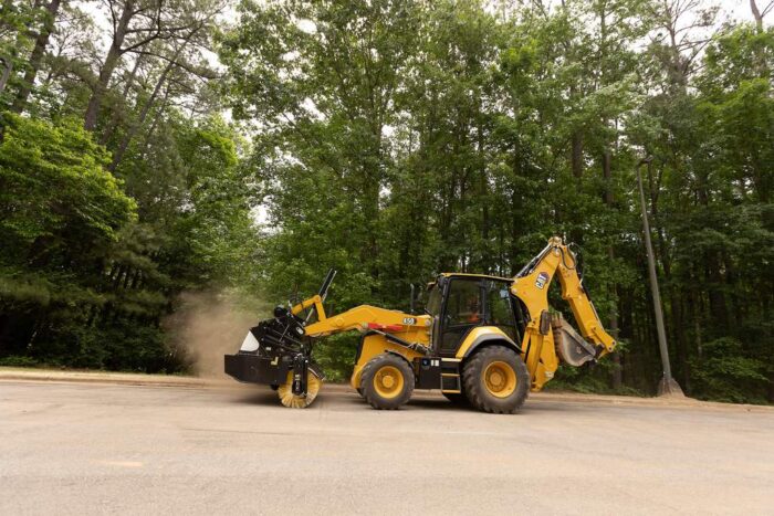 Caterpillar 450 Backhoe Loader with broom attachment