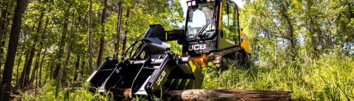 JCB 2TS-7T compact track loader with a grapple attachment working in a forest