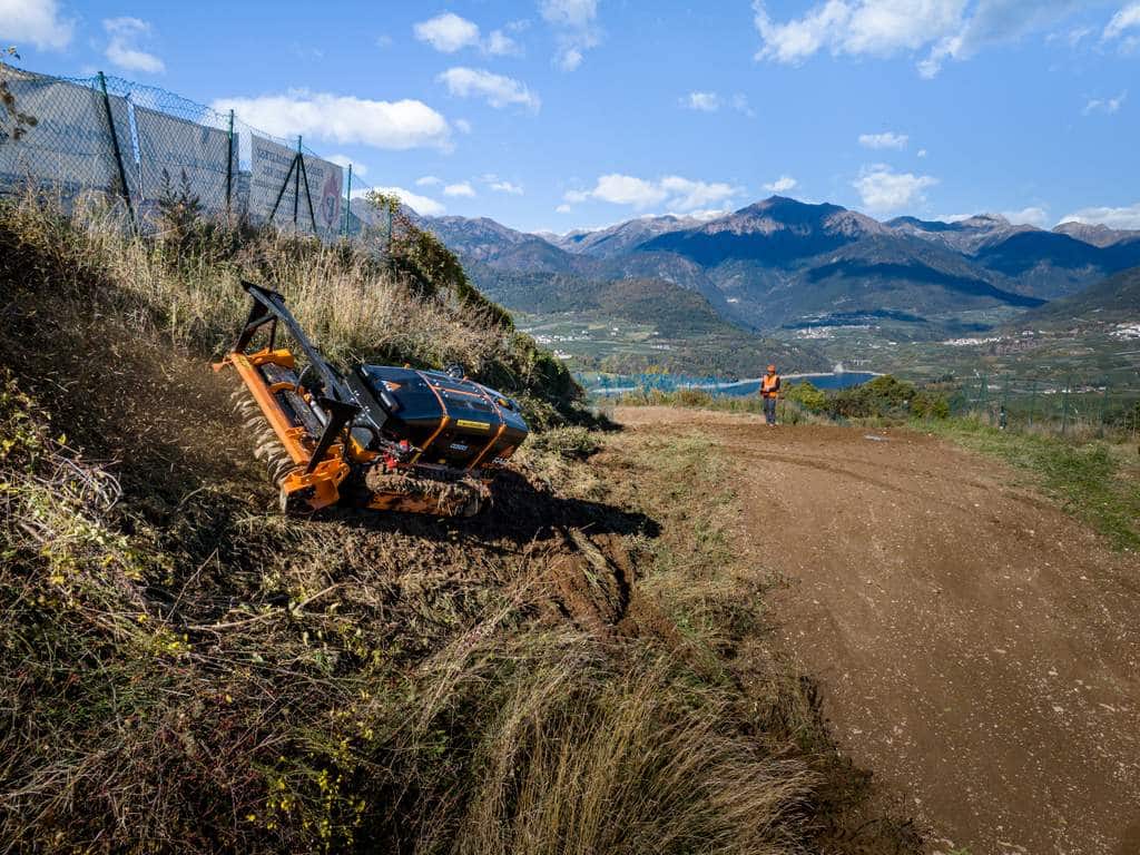 FAE RCU45 Ultra-Compact Remote Carrier working on a hill with an operator in the background
