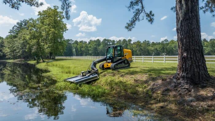 JCB 4TS Teleckid brush mowing near a river bank