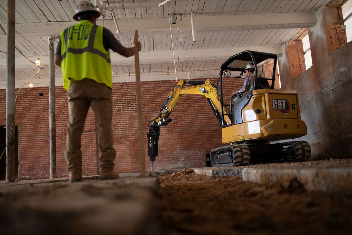 Caterpillar excavator with hammer attachment